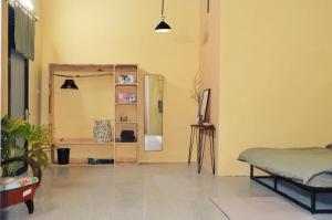 a living room with a bed and a mirror at Nhà Đậu Homestay Măng Đen - 75 Võ Thị Sáu in Kon Plong