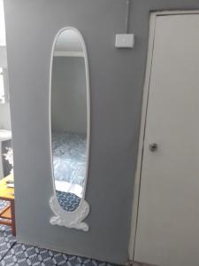 a mirror hanging on a wall in a room at Home Away From Home in Nadi
