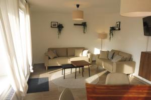 a living room with a couch and a table at Ferienhaus Marienhafe in Marienhafe