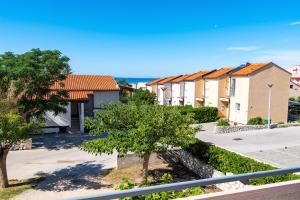 a row of houses in a residential neighbourhood at Bady Apartments with BBQ in Novalja