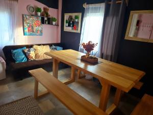a living room with a wooden table and a couch at DAGNA summer house in Šunupis