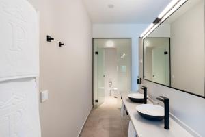 a bathroom with two sinks and a mirror at Parador de Molina de Aragón in Molina de Aragón +32 photos