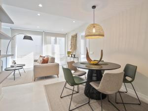 a living room with a table and chairs at Sitges Spaces Deluxe Comfort Flat-Monthly Rentals in Sitges