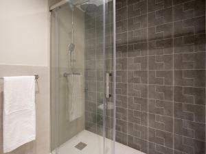a shower with a glass door in a bathroom at Sitges Spaces Deluxe Comfort Flat-Monthly Rentals in Sitges +13 photos