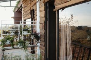 a window with a view of the mountains at Nhà Đậu Homestay Măng Đen - 75 Võ Thị Sáu in Kon Plong