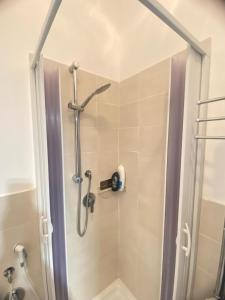 a shower with a glass door in a bathroom at TaorminaCentre Panorama in Taormina