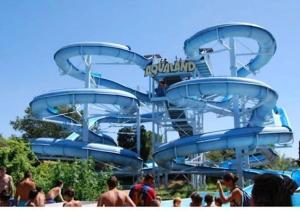 a blue water slide at a water park at Studio Cabine Vue Port avec parking privé in Cap d'Agde