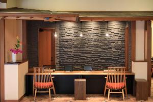 a bar with three chairs and a stone wall at Otogitei Kofu in Achi +107 photos
