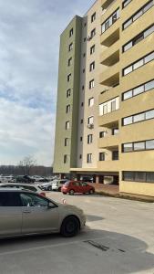 a car parked in a parking lot in front of a building at Kyr house 2 in Piteşti