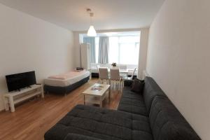 a living room with a couch and a table at Hauptbahnhof 32 in Vienna
