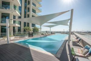 a swimming pool on the roof of a building at Aven Apartment Dubai 2BR-2209 in Urban Oasis by Missoni-Business Bay Dubai in Ghantoot
