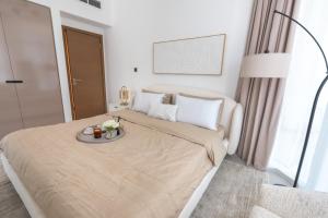 a bedroom with a bed with a tray of flowers on it at Aven Apartment Dubai 2BR-2209 in Urban Oasis by Missoni-Business Bay Dubai in Ghantoot +26 photos