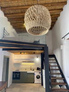 a kitchen with a staircase and a chandelier at SPITI Anastasia in Kathikas