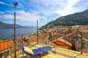 a balcony with a chair and a view of the water at Casa Sofia in Cannobio
