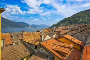 a view of a town with orange roofs and the water at Casa Sofia in Cannobio