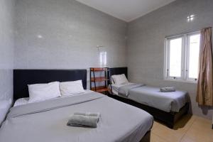 Postel nebo postele na pokoji v ubytování Urbanview Ava Guest House Goa Gong + 17 fotografií