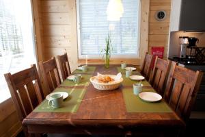 a wooden table with a bowl of food on it at Villa Kilpikonna in Mikkeli +7 photos