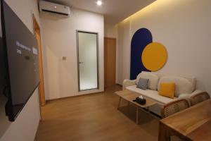 a living room with a couch and a tv at Casabella Homestay 202 Batam Penuin in Nagoya +11 photos
