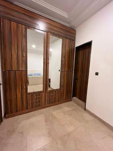 a room with wood paneling and a mirror at As at home! in Ouagadougou