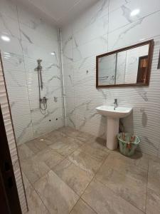 a bathroom with a shower and a sink at As at home! in Ouagadougou