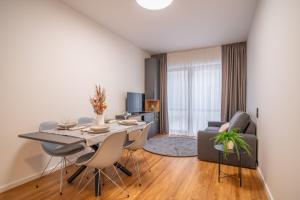 a dining room and living room with a table and chairs at City Pop 2Night Prague - Self check-in in Prague