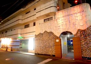 a building with a wall that has a painting on it at Hotel Plage (Adult Only) in Yokohama