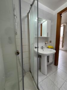 a bathroom with a sink and a glass shower at Casa FLAVIA in Serracapriola +9 photos