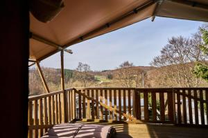 a room with a bed on a wooden balcony at AlbCamping Westerheim in Westerheim