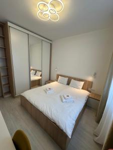 a bedroom with a bed with two plates on it at Citadel 2 - Powered By NEO - Free Parking in Timişoara
