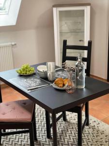 a black table with a plate of food on it at Ferienwohnung Heinz in Sankt Wendel