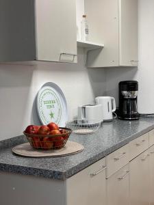 a kitchen counter with a bowl of tomatoes on a plate at Ferienwohnung Heinz in Sankt Wendel +22 photos