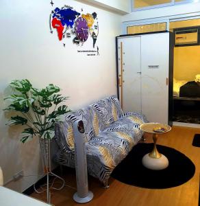 a living room with a chair and a table at Cuddle & Cradle Staycation at The Celandine in Manila