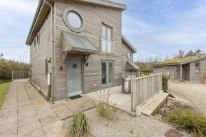 a house with a wooden porch and a fence at 55 Una in Carbis Bay