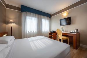 Ένα ή περισσότερα κρεβάτια σε δωμάτιο στο iH Hotels Padova Admiral