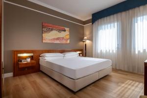 Ένα ή περισσότερα κρεβάτια σε δωμάτιο στο iH Hotels Padova Admiral