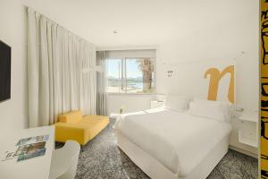 a hotel room with a bed and a window at nhow Marseille in Marseille