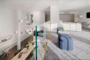 a hotel room with a bed and a glass staircase at nhow Marseille in Marseille