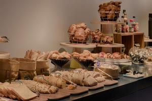 a table topped with lots of different types of bread at nhow Marseille in Marseille