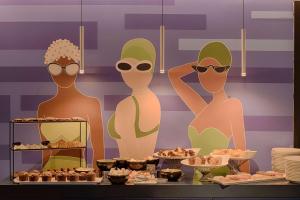 a display of three mannequins wearing sunglasses in a buffet of food at nhow Marseille in Marseille