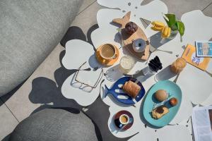 a table topped with plates of food and a cup of coffee at nhow Marseille in Marseille