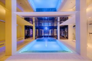 a swimming pool in the middle of a building at nhow Marseille in Marseille