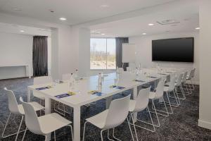 a conference room with a long table and chairs at nhow Marseille in Marseille