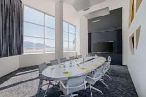 a conference room with a long table and chairs at nhow Marseille in Marseille