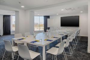 a large conference room with a long table and chairs at nhow Marseille in Marseille