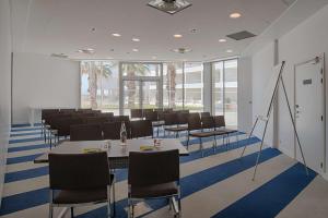 a conference room with tables and chairs and windows at nhow Marseille in Marseille