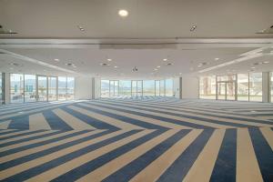 an empty room with blue and white stripes on the floor at nhow Marseille in Marseille