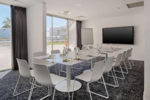a conference room with a long table and chairs at nhow Marseille in Marseille