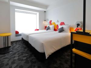 Postel nebo postele na pokoji v ubytování ibis Styles Tokyo Bay