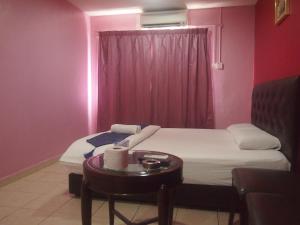 A bed or beds in a room at Senawang Star Hotel