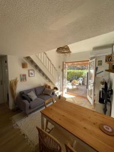 a living room with a couch and a table at Maison de vacance bord de mer in Le Barcarès